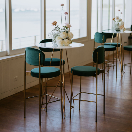high bar table with high stools with a floral centrepiece