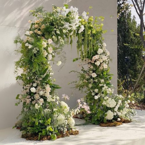 wedding arch with natural florals and greenery
