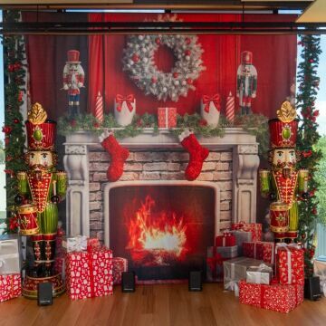 Christmas fireplace backdrop with nutcracker props and presents
