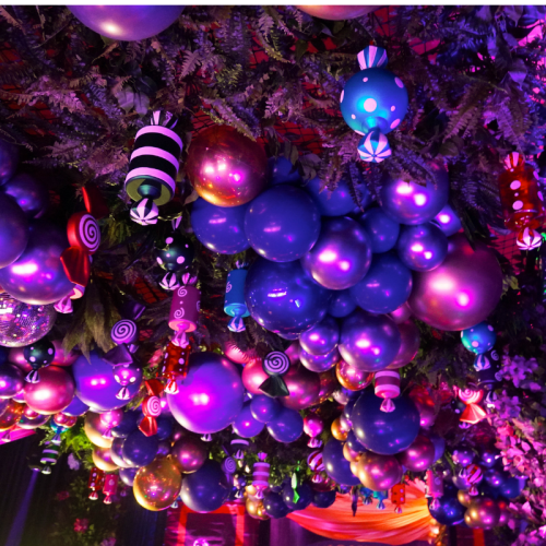 large candy decor and balloons hanging from roof
