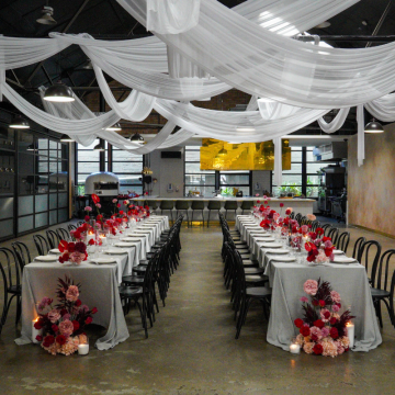 wedding reception with white drape organically over beams
