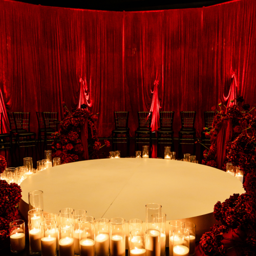 round ceremony wedding setup red draped room