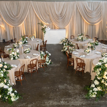 chiffon draped backdrop behind bar