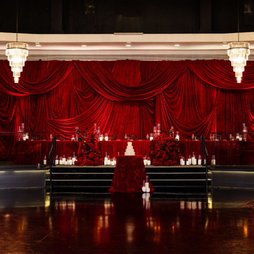 chiffon draped backdrop behind bar