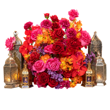 Moroccan Sunset Floral Feature with vibrant artificial florals, roses, orchids and decorative lanterns for Arabian Night wedding and event styling.