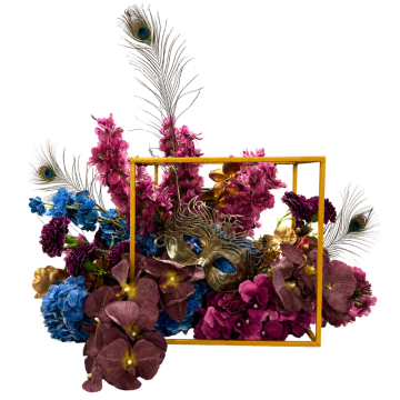 Peacock Masquerade Floral Feature with blue and purple artificial flowers, peacock feathers and faux florals in a gold cube for luxury event styling.
